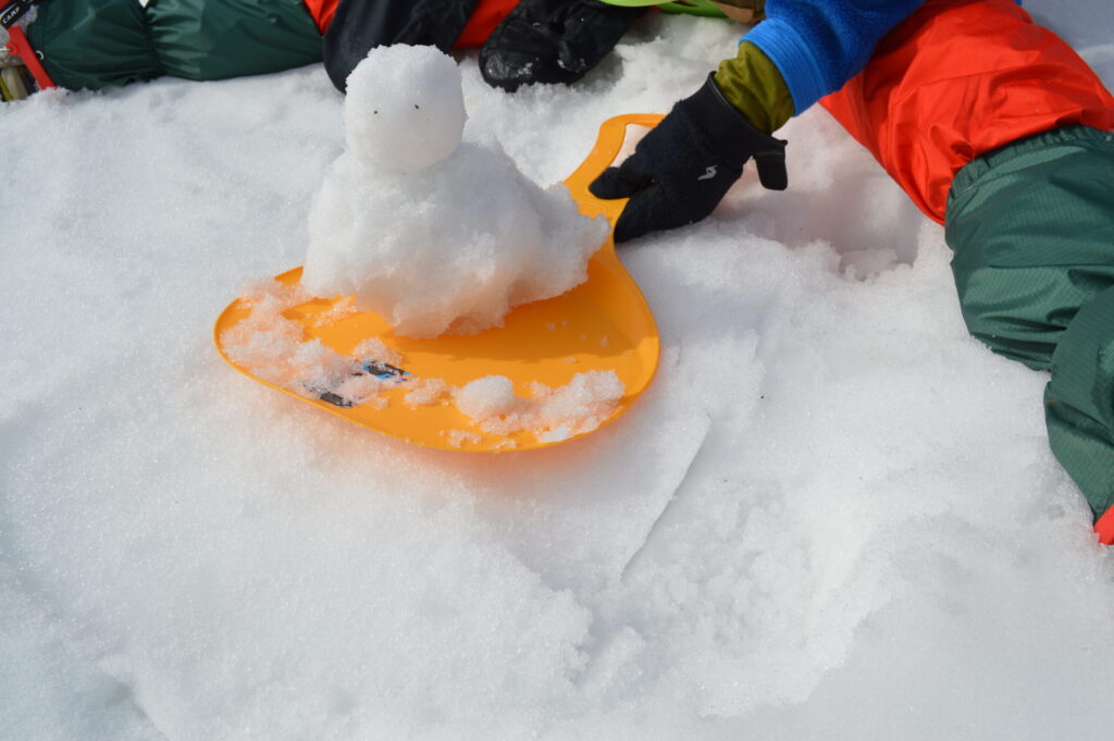 雪山歩きで休憩中に作った雪だるまの写真